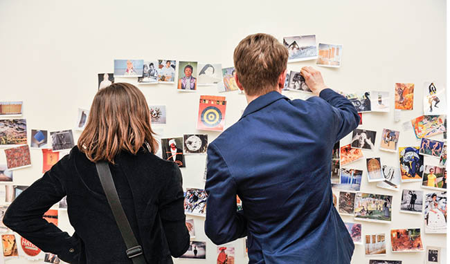 People looking gallery wall